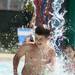 A young swimmer passes under a waterfall at Veterans Memorial Park Pool on Tuesday afternoon.  Melanie Maxwell I AnnArbor.com
